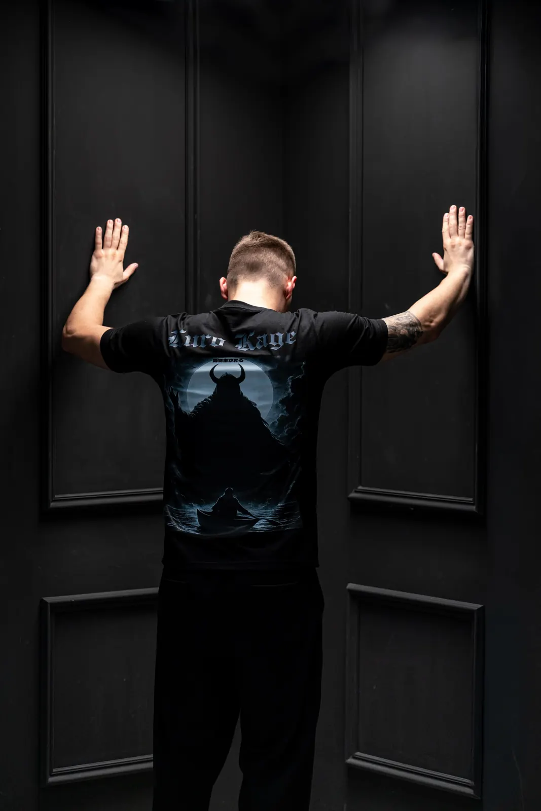 Model wearing Kuro Kage oversized tee with oni demon graphic in a Tokyo alley